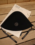 Premium black sauna hat made from 100% Australian merino wool with cotton storage bag in a traditional sauna.