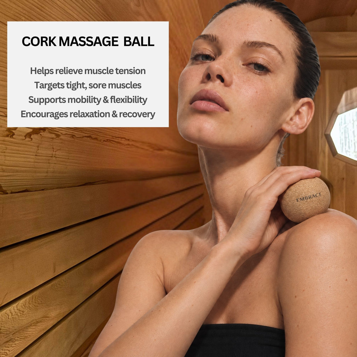 Woman using the Embrace Cork Massage Ball on her shoulder in a sauna to help relieve muscle tension, support mobility, and encourage relaxation.